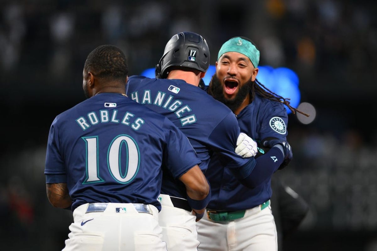 Jun 12, 2024; Seattle, Washington, USA; Seattle Mariners Victor Robles (10) and pinch hitter Mitch Haniger (17) and shortstop J.P. Crawford (3) celebrate after Haniger hit a walk-off single against the Chicago White Sox during the tenth inning at T-Mobile Park. Mandatory Credit: Steven Bisig-USA TODAY Sports