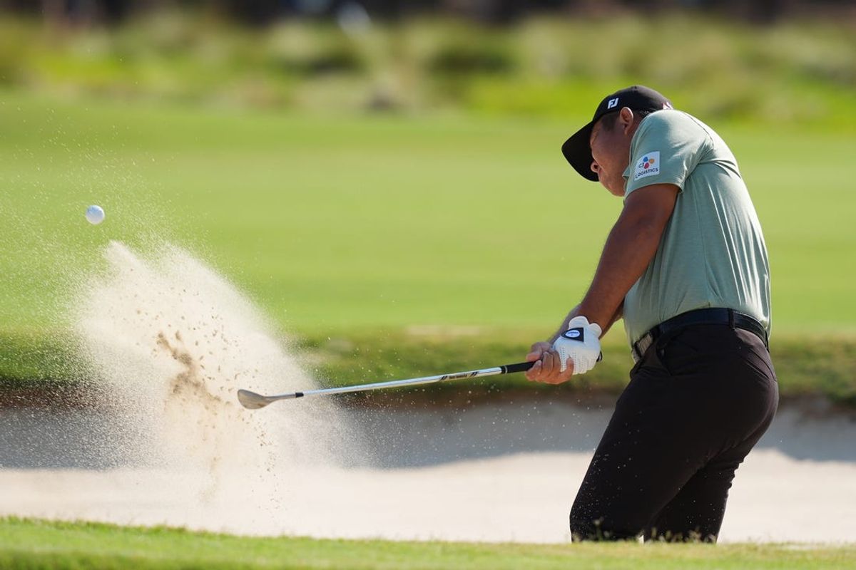 Jun 13, 2024; Pinehurst, North Carolina, USA; Byeong Hun An hits from the bunker on the eleventh hole during the first round of the U.S. Open golf tournament. Mandatory Credit: Jim Dedmon-USA TODAY Sports