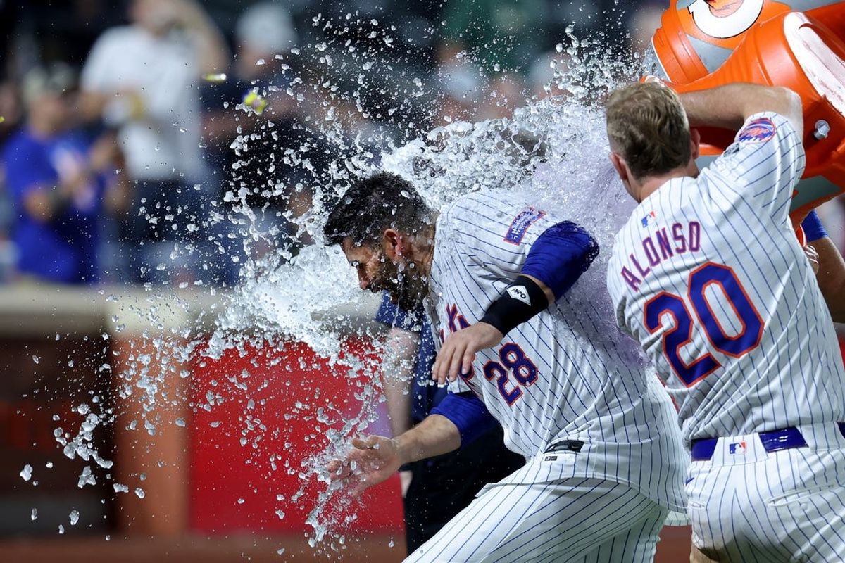 Jun 13, 2024; New York City, New York, USA; New York Mets first baseman Pete Alonso (20) gives designated hitter J.D. Martinez (28) a Gatorade bath after Martinez hit a ninth inning walkoff two run home run against the Miami Marlins at Citi Field. Mandatory Credit: Brad Penner-USA TODAY Sports