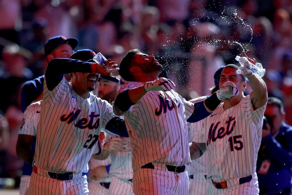 Jun 13, 2024; New York City, New York, USA; New York Mets third baseman Mark Vientos (27) and right fielder Tyrone Taylor (15) pour water on designated hitter J.D. Martinez (28) after his ninth inning walkoff two run home run against the Miami Marlins at Citi Field. Mandatory Credit: Brad Penner-USA TODAY Sports