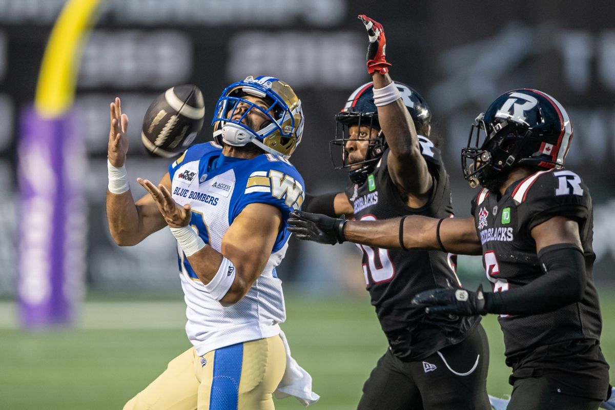 Jun 13, 2024; Ottawa, Ontario, CAN; Winnipeg Blue Bombers wide receiver Nic Demski (10) catches the ball in front of Ottawa REDBLACKS defensive backs Alonzo Addae (20) and Adarius Pickett (6) in the first half at TD Place. Mandatory Credit: Marc DesRosiers-USA TODAY Sports
