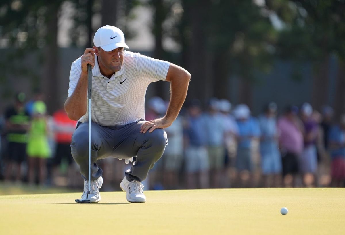 Jun 14, 2024; Pinehurst, North Carolina, USA; Scottie Scheffler lines up a putt on the 13th hole during the second round of the U.S. Open golf tournament at Pinehurst No. 2. Mandatory Credit: John David Mercer-USA TODAY Sports