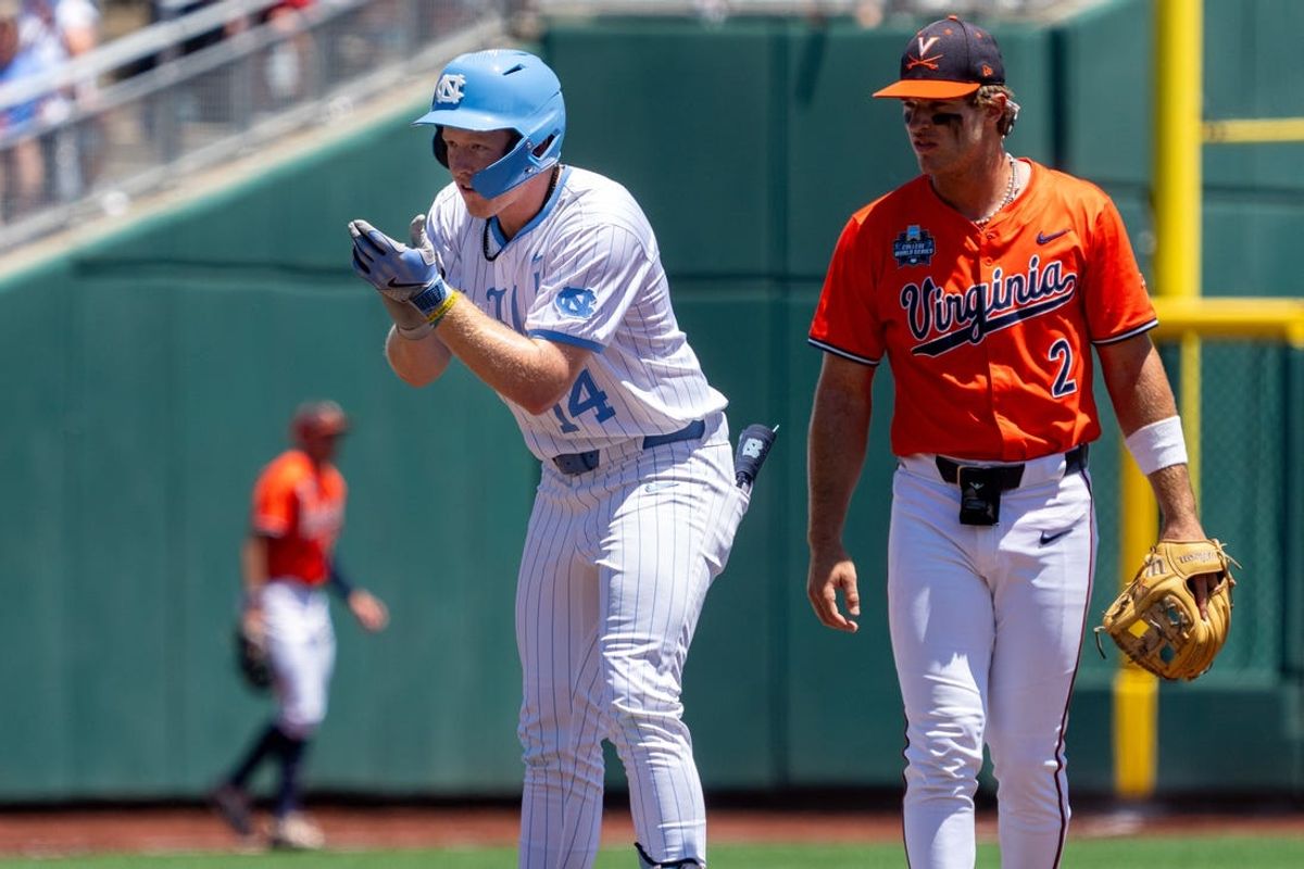 Jun 14, 2024; Omaha, NE, USA; North Carolina Tar Heels first baseman Parks Harber (14) celebrates after hitting a double during the first inning against the Virginia Cavaliers at Charles Schwab Filed Omaha. Mandatory Credit: Dylan Widger-USA TODAY Sports