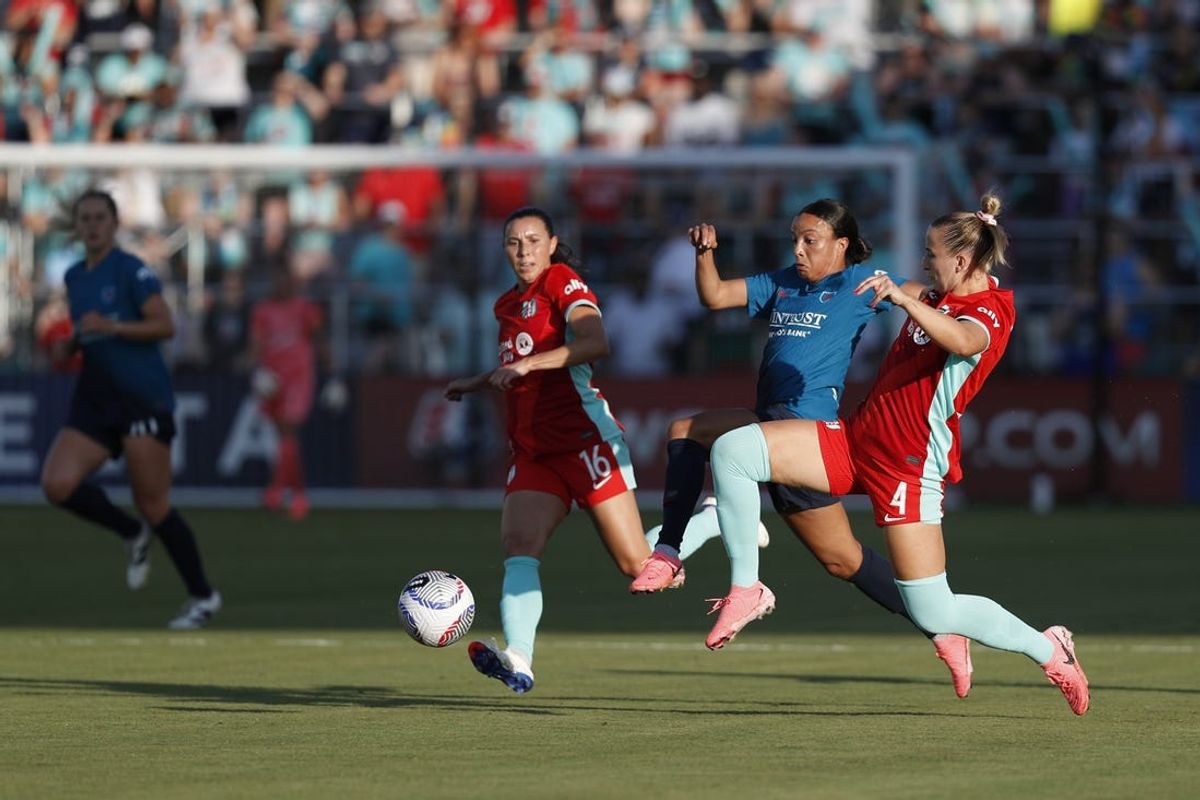 Jun 14, 2024; Kansas City, Missouri, USA; Kansas City Current defender Hailie Mace (4) tackles the ball away from Chicago Red Stars forward Mallory Swanson (9) in the first half at CPKC Stadium. Mandatory Credit: Kylie Graham-USA TODAY Sports