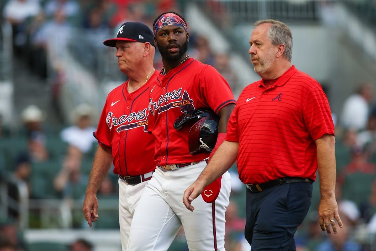 Jun 14, 2024; Atlanta, Georgia, USA; Atlanta Braves manager Brian Snitker (43) and center fielder Michael Harris II (23) walk off the field with assistant athletic trainer Jeff Stephenson after an injury against the Tampa Bay Rays in the first inning at Truist Park. Mandatory Credit: Brett Davis-USA TODAY Sports