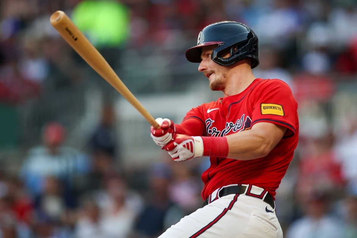 Jun 14, 2024; Atlanta, Georgia, USA; Atlanta Braves catcher Sean Murphy (12) hits a single against the Tampa Bay Rays in the second inning at Truist Park. Mandatory Credit: Brett Davis-USA TODAY Sports