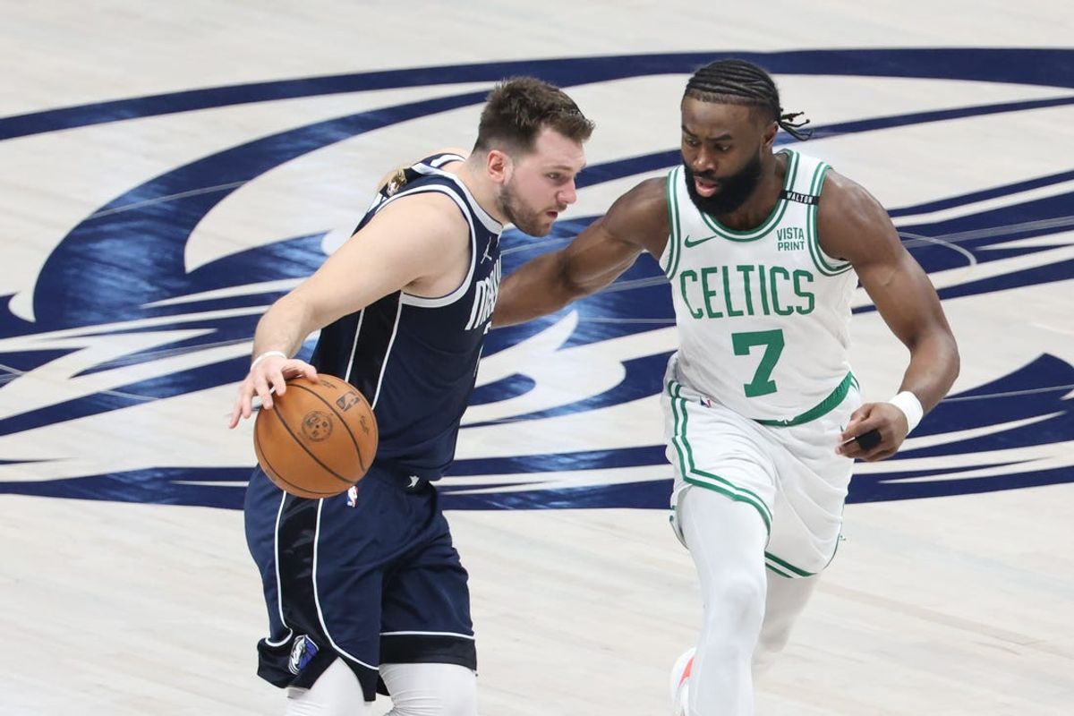 Jun 14, 2024; Dallas, Texas, USA; Dallas Mavericks guard Luka Doncic (77) dribbles against Boston Celtics guard Jaylen Brown (7) during the first half of game four of the 2024 NBA Finals at American Airlines Center. Mandatory Credit: Kevin Jairaj-USA TODAY Sports