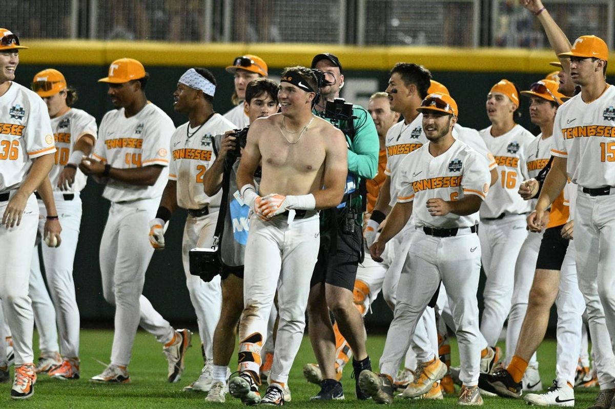 Jun 14, 2024; Omaha, NE, USA;  Tennessee Volunteers left fielder Dylan Dreiling (8) (no shirt) celebrates the win with teammates against the Florida State Seminoles at Charles Schwab Filed Omaha. Mandatory Credit: Steven Branscombe-USA TODAY Sports