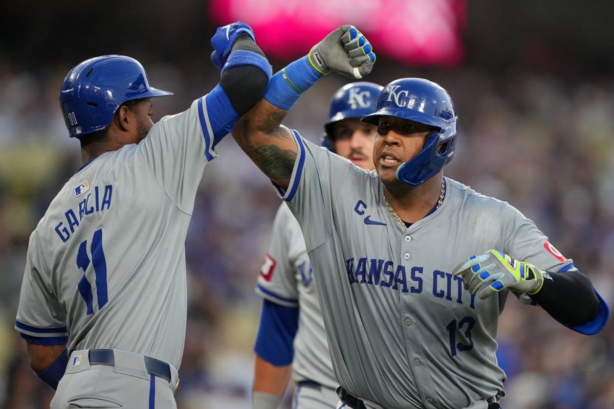 Jun 14, 2024; Los Angeles, California, USA; Kansas City Royals catcher Salvador Perez (13) celebrates with third baseman Maikel Garcia (11) after hitting a three-run home run in the second inning against the Los Angeles Dodgers at Dodger Stadium. Mandatory Credit: Kirby Lee-USA TODAY Sports