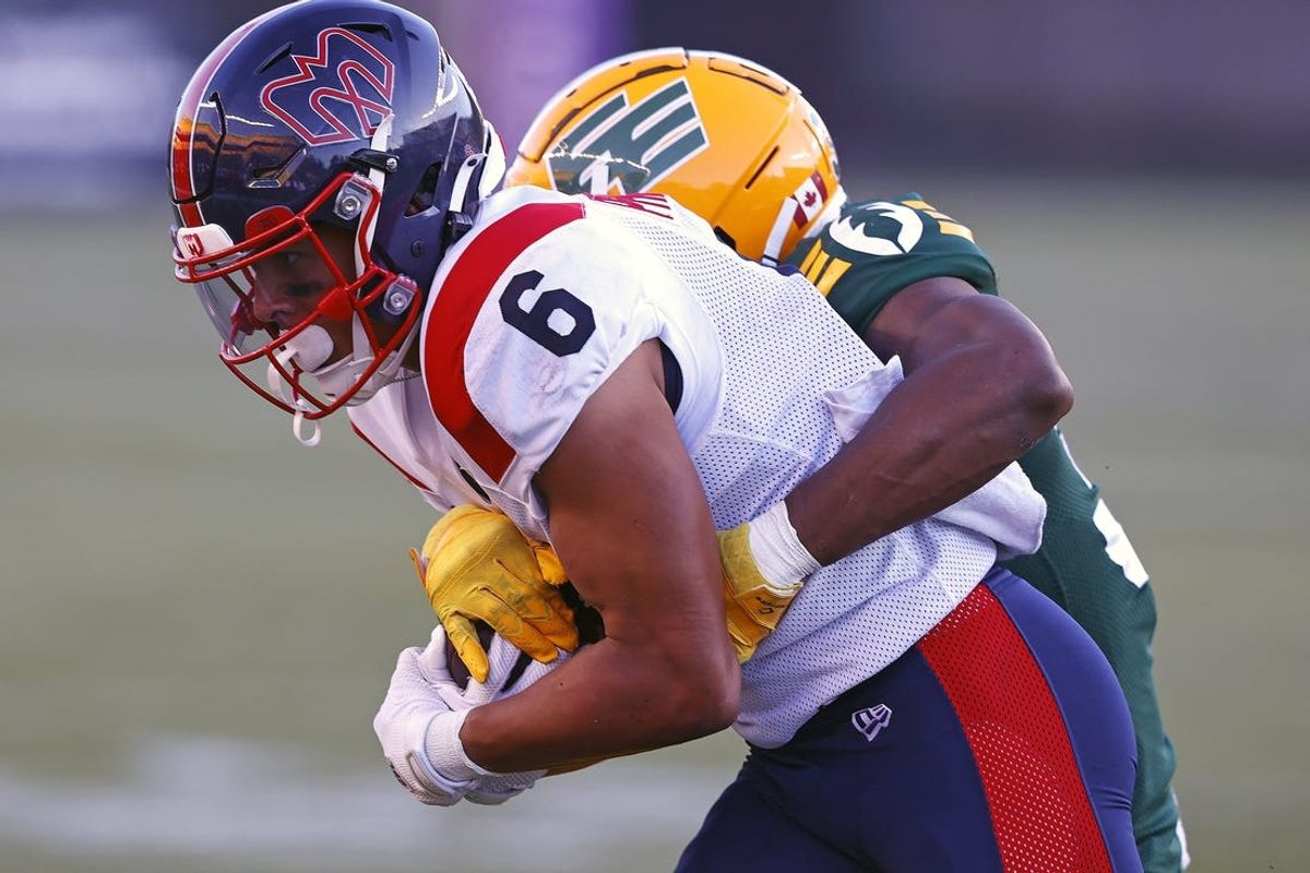 Jun 14, 2024; Edmonton, Alberta, CAN; Edmonton Elks defensive back Leon O'Neal Jr. (32) tackles Montreal Alouettes wide receiver Tyson Philpot (6) during the second half at Commonwealth Stadium. Mandatory Credit: Perry Nelson-USA TODAY Sports