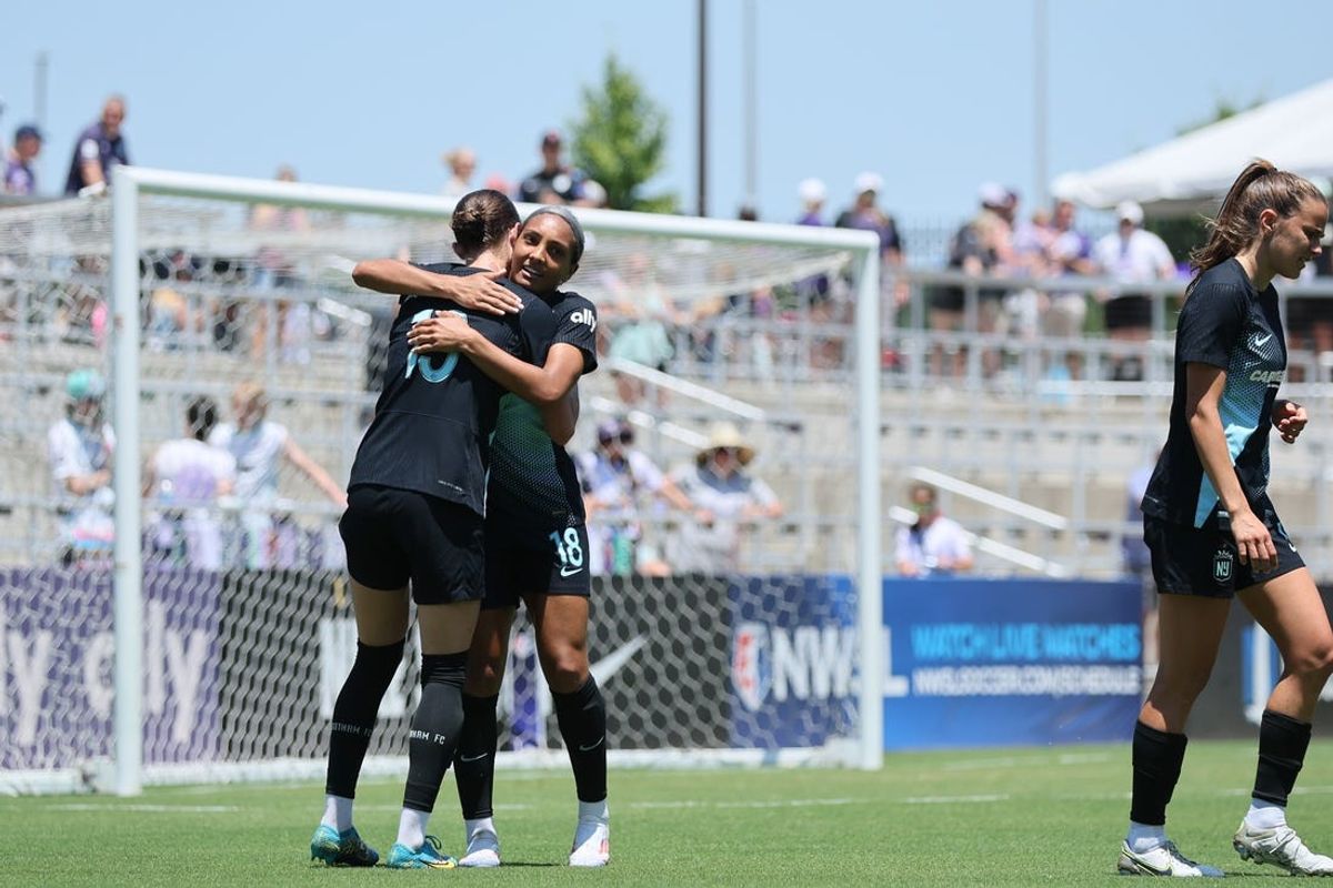 Jun 15, 2024; Louisville, Kentucky, USA; NJ/NY Gotham FC midfielder Yazmeen Ryan (18) hugs forward Ella Stevens (13) after scoring a goal in the second half against Racing Louisville FC at Lynn Family Stadium. Mandatory Credit: EM Dash-USA TODAY Sports