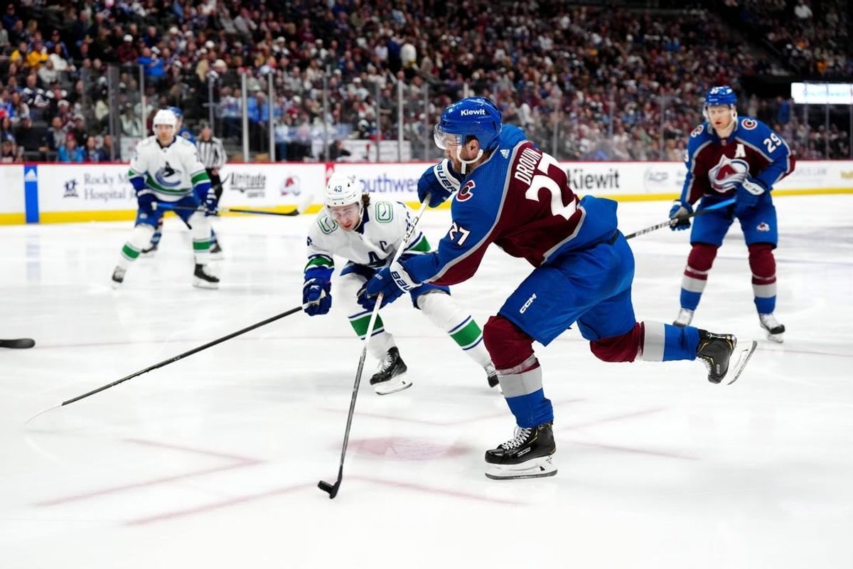 Feb 20, 2024; Denver, Colorado, USA; Colorado Avalanche left wing Jonathan Drouin (27) shoots the puck in the second period against the Vancouver Canucks at Ball Arena.