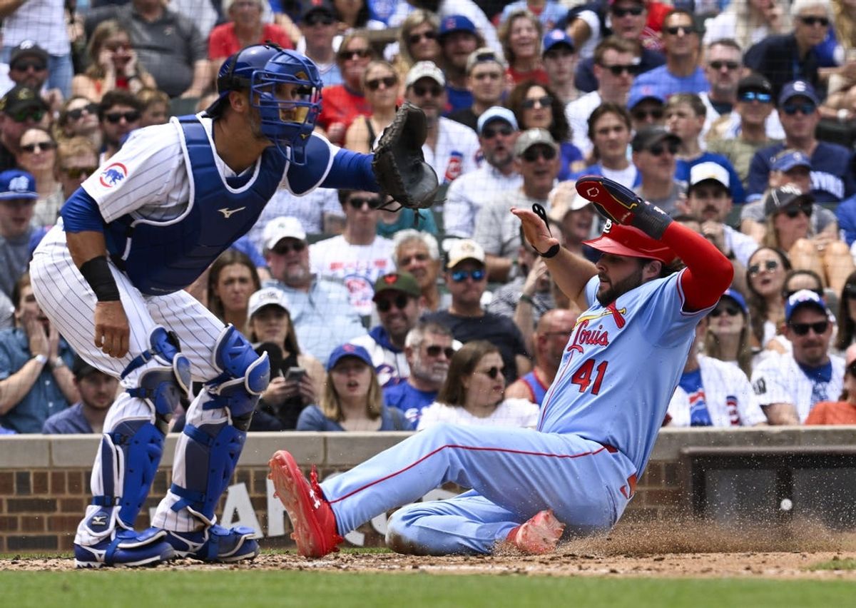 Jun 15, 2024; Chicago, Illinois, USA;  St. Louis Cardinals outfielder Alec Burleson (41) scores past Chicago Cubs catcher Yan Gomes (15) during the fourth inning at Wrigley Field. Mandatory Credit: Matt Marton-USA TODAY Sports