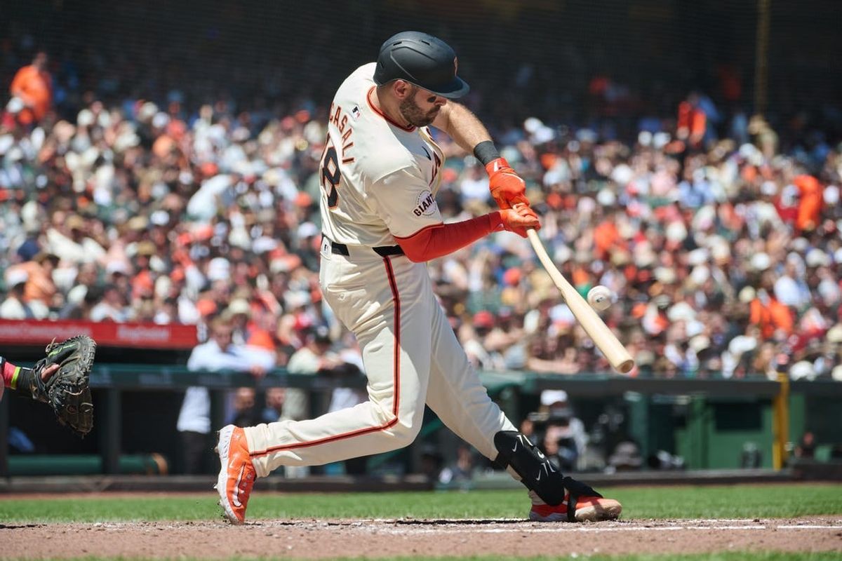 Jun 15, 2024; San Francisco, California, USA; San Francisco Giants catcher Curt Casali (18) hits a single against the Los Angeles Angels during the fifth inning at Oracle Park. Mandatory Credit: Robert Edwards-USA TODAY Sports