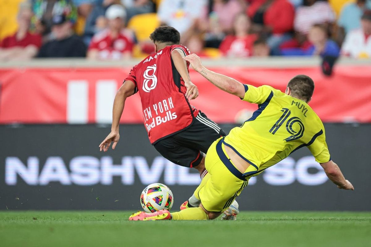 Jun 15, 2024; Harrison, New Jersey, USA; New York Red Bulls midfielder Frankie Amaya (8) battle for the ball against  Nashville SC midfielder Alex Muyl (19) during the first half at Red Bull Arena. Mandatory Credit: Vincent Carchietta-USA TODAY Sports