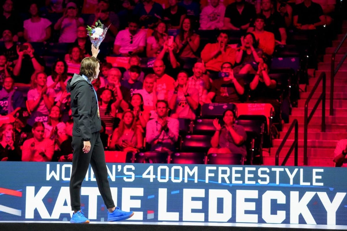 Katie Ledecky waves to the crowd after receiving her medal for the 400 freestyle final Saturday, June 15, 2024, during the first day of competition for the U.S. Olympic Team Swimming Trials at Lucas Oil Stadium in Indianapolis.