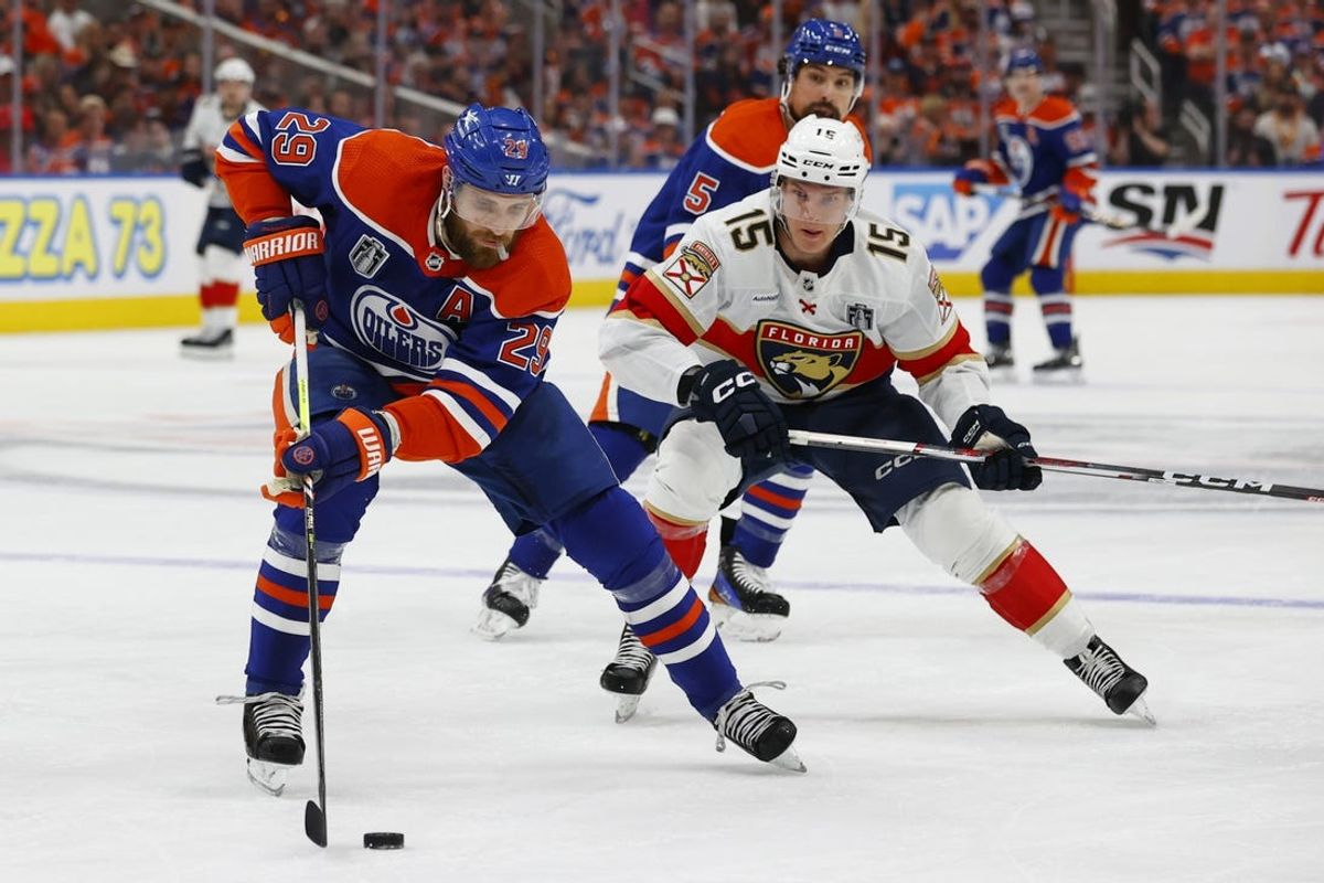 Jun 15, 2024; Edmonton, Alberta, CAN; Edmonton Oilers center Leon Draisaitl (29) skates with the puck defined by Florida Panthers center Anton Lundell (15) in the first period in game four of the 2024 Stanley Cup Final at Rogers Place. Mandatory Credit: Perry Nelson-USA TODAY Sports