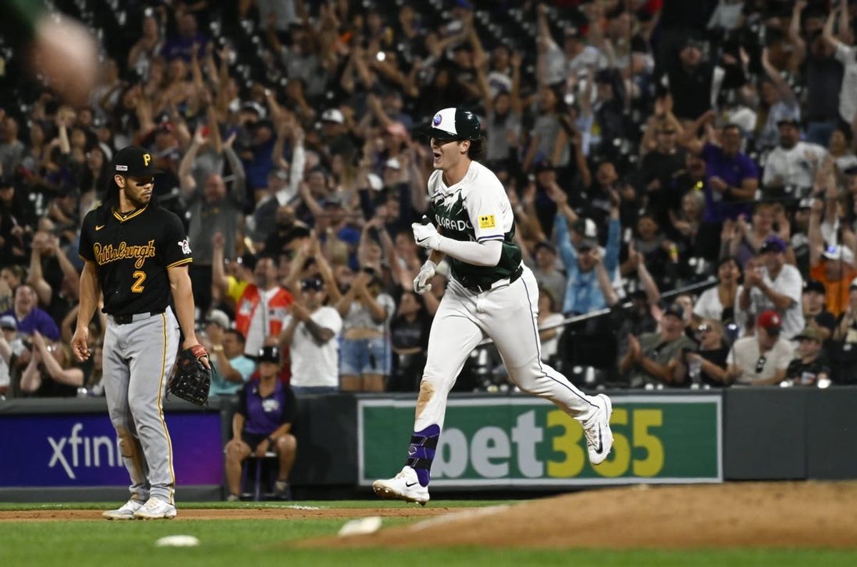 Jun 15, 2024; Denver, Colorado, USA; Colorado Rockies outfield Michael Toglia (4) smiles while running the bases after hitting a grand slam in the eighth inning against the Pittsburgh Pirates at Coors Field. Mandatory Credit: John Leyba-USA TODAY Sports
