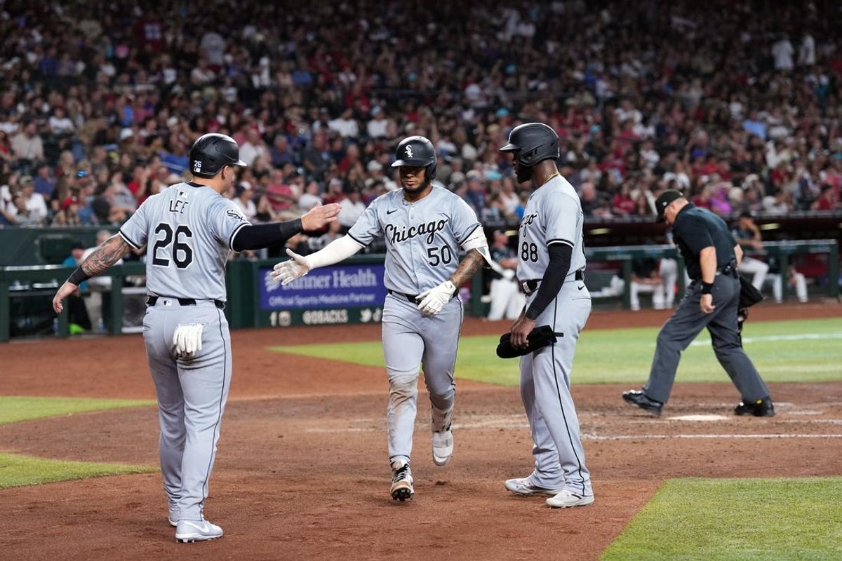 Jun 15, 2024; Phoenix, Arizona, USA; Chicago White Sox third base Lenyn Sosa (50) slaps hands with Chicago White Sox catcher Korey Lee (26) and Chicago White Sox outfielder Luis Robert Jr. (88) after hitting a three run home run against the Arizona Diamondbacks during the seventh inning at Chase Field. Mandatory Credit: Joe Camporeale-USA TODAY Sports