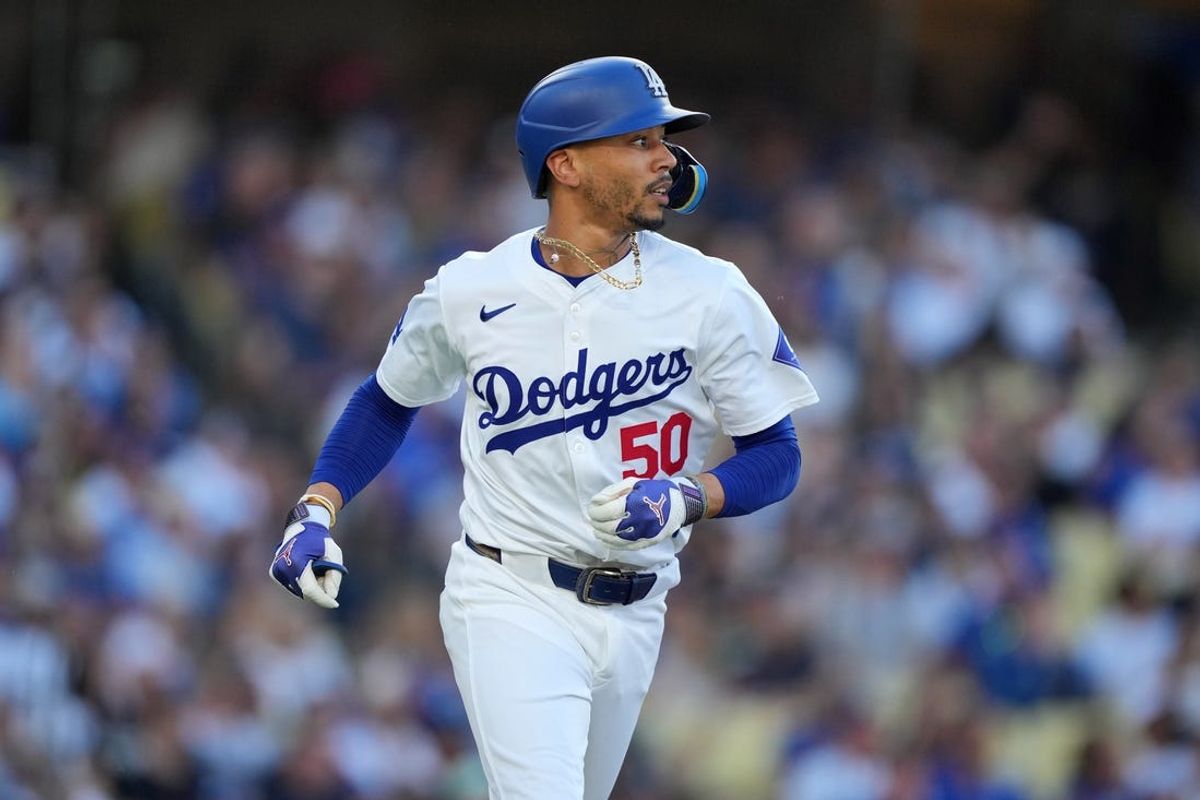 Jun 15, 2024; Los Angeles, California, USA; Los Angeles Dodgers shortstop Mookie Betts (50) runs to first base in the third inning against the Kansas City Royals at Dodger Stadium. Mandatory Credit: Kirby Lee-USA TODAY Sports