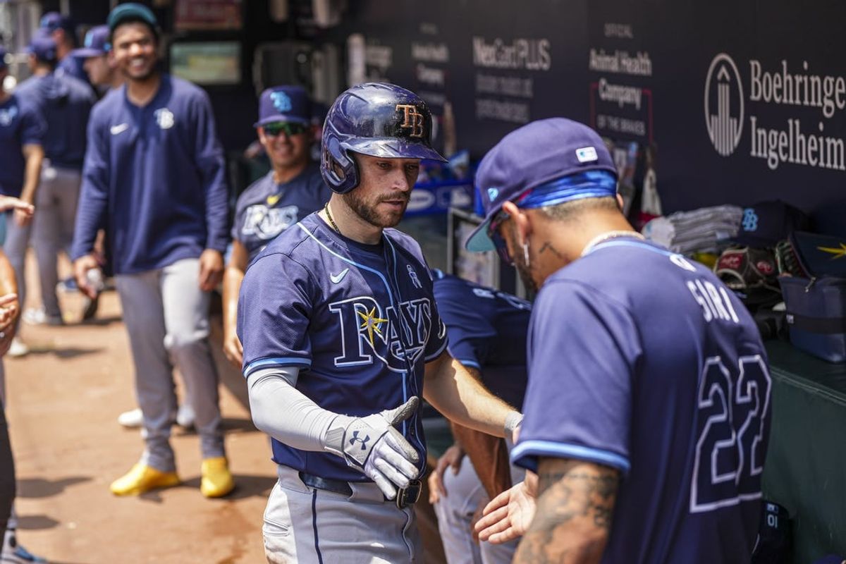 Jun 16, 2024; Cumberland, Georgia, USA; Tampa Bay Rays second baseman Brandon Lowe (8) reacts with center fielder Jose Siri (22) after hitting a home run against the Atlanta Braves during the third inning at Truist Park. Mandatory Credit: Dale Zanine-USA TODAY Sports