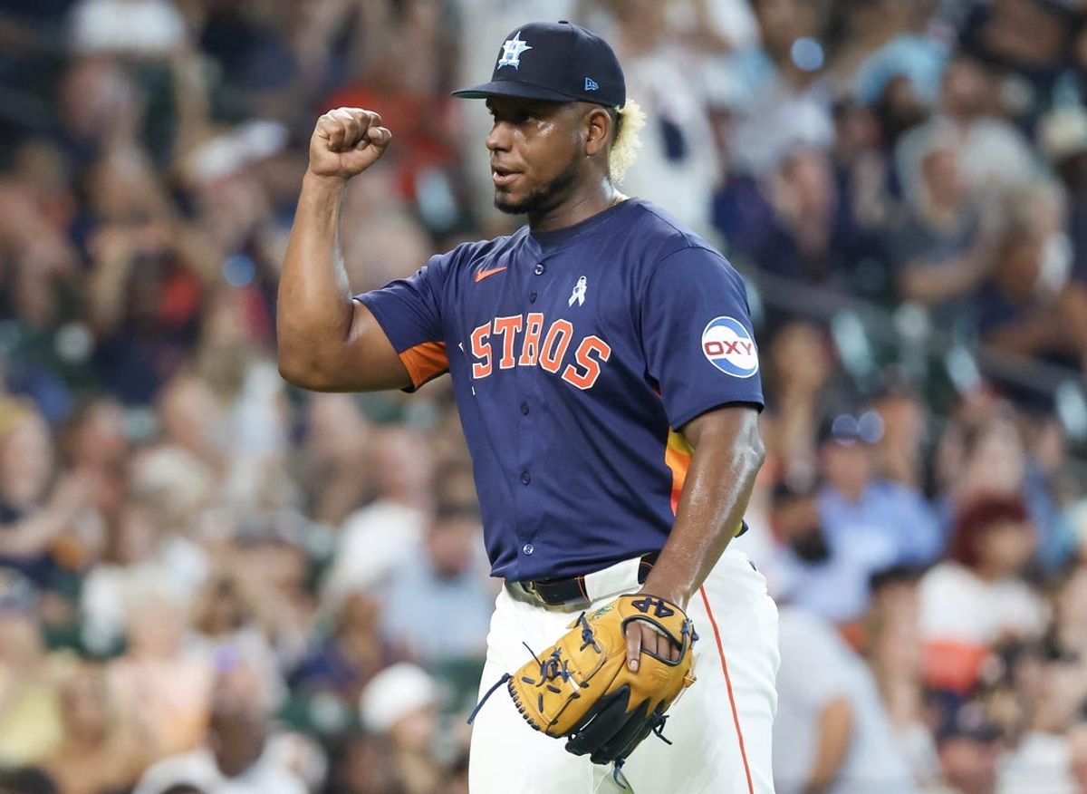 Jun 16, 2024; Houston, Texas, USA;  Houston Astros starting pitcher Ronel Blanco (56) reacts to center fielder Chas McCormick (20) catch against the Detroit Tigers in the seventh inning at Minute Maid Park. Mandatory Credit: Thomas Shea-USA TODAY Sports