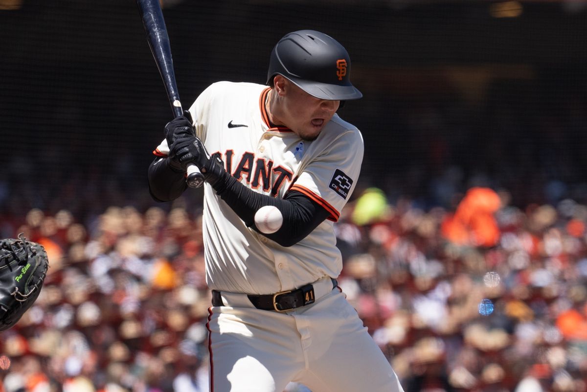 Jun 16, 2024; San Francisco, California, USA;  San Francisco Giants first base Wilmer Flores (41) gets hit by a pitch during the second inning against the Los Angeles Angels at Oracle Park. Mandatory Credit: Stan Szeto-Imagn Images