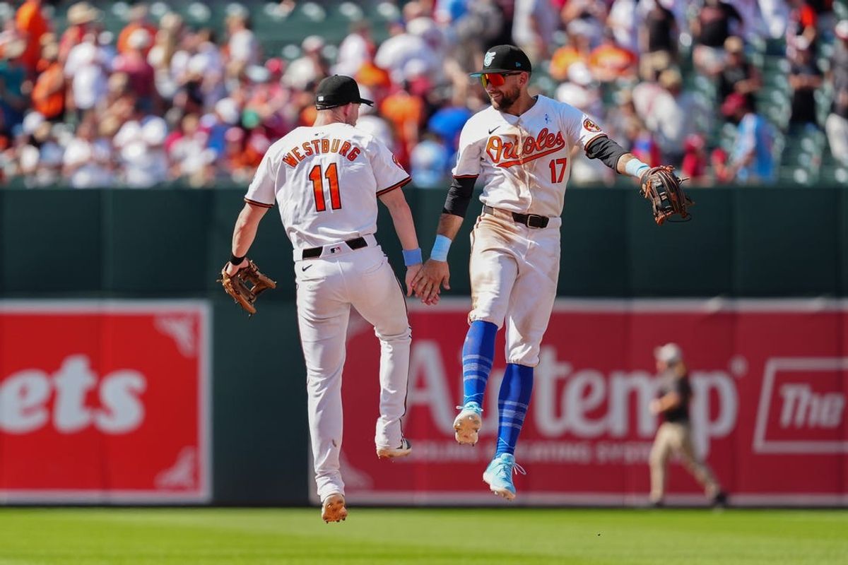 Jun 16, 2024; Baltimore, Maryland, USA; Baltimore Orioles second baseman Jordan Westburg (11) and right fielder Colton Cowser (17) leap and low five to celebrate the victory against the Philadelphia Phillies after the ninth inning at Oriole Park at Camden Yards. Mandatory Credit: Gregory Fisher-USA TODAY Sports