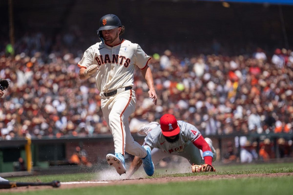 Jun 16, 2024; San Francisco, California, USA;  San Francisco Giants shortstop Brett Wisely (0) gets tagged out by Los Angeles Angels third base Luis Rengifo (2) during the third inning at Oracle Park. Mandatory Credit: Stan Szeto-USA TODAY Sports
