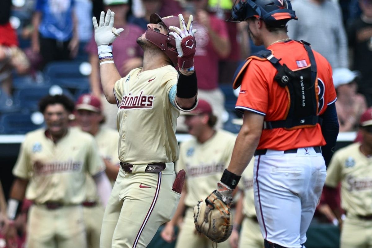 Jun 16, 2024; Omaha, NE, USA;  Florida State Seminoles left fielder Jaime Ferrer (7) celebrates hitting a home run as Virginia Cavaliers catcher Jacob Ference (28) looks on during the fifth inning at Charles Schwab Field Omaha. Mandatory Credit: Steven Branscombe-USA TODAY Sports