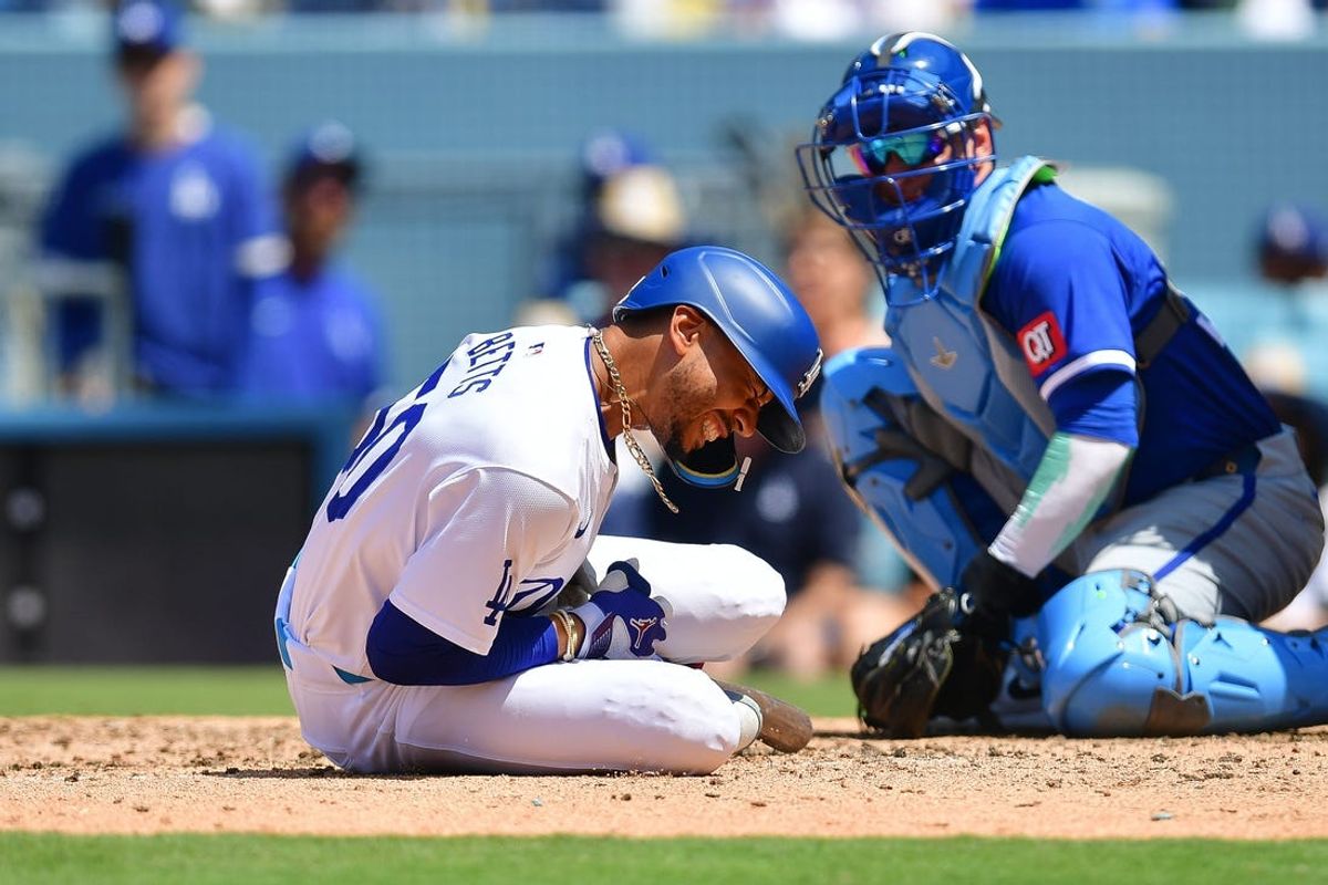 Jun 16, 2024; Los Angeles, California, USA; Los Angeles Dodgers shortstop Mookie Betts (50) reacts after being hit by pitch from Kansas City Royals pitcher Dan Altavilla (54) during the seventh inning at Dodger Stadium. Mandatory Credit: Gary A. Vasquez-USA TODAY Sports