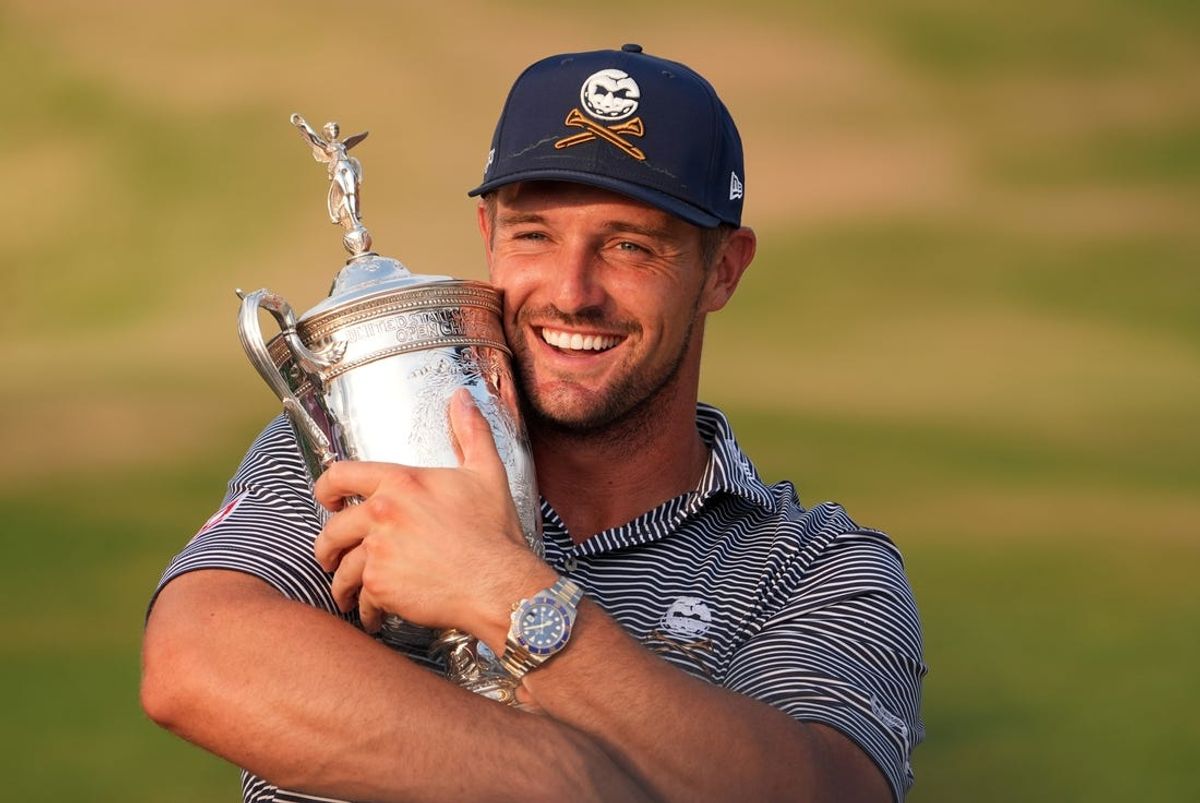Jun 16, 2024; Pinehurst, North Carolina, USA; Bryson DeChambeau celebrates with the trophy after winning the U.S. Open golf tournament. Mandatory Credit: John David Mercer-USA TODAY Sports