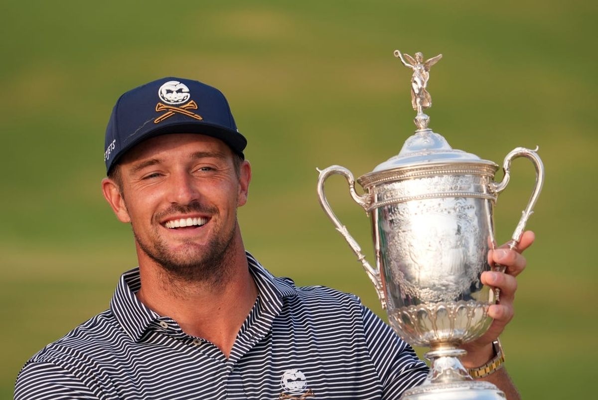 Jun 16, 2024; Pinehurst, North Carolina, USA; Bryson DeChambeau celebrates with the trophy after winning the U.S. Open golf tournament. Mandatory Credit: John David Mercer-USA TODAY Sports