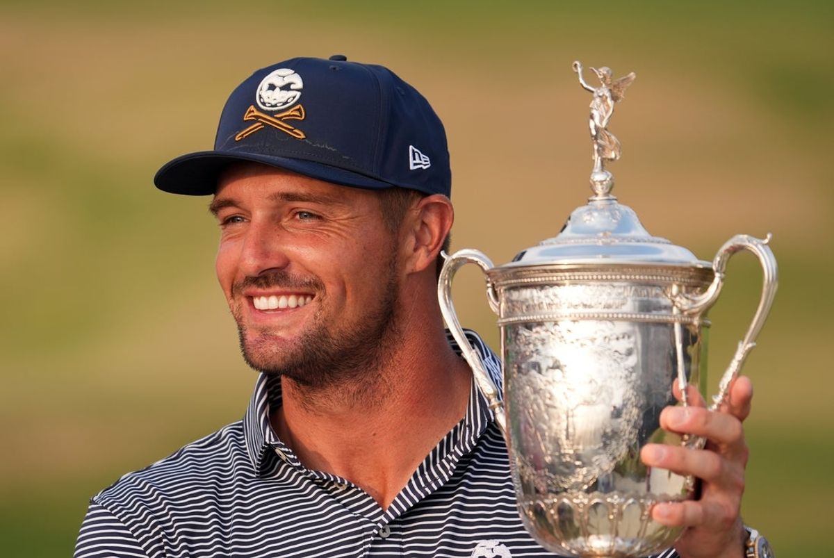 Jun 16, 2024; Pinehurst, North Carolina, USA; Bryson DeChambeau celebrates with the trophy after winning the U.S. Open golf tournament. Mandatory Credit: John David Mercer-Imagn Images