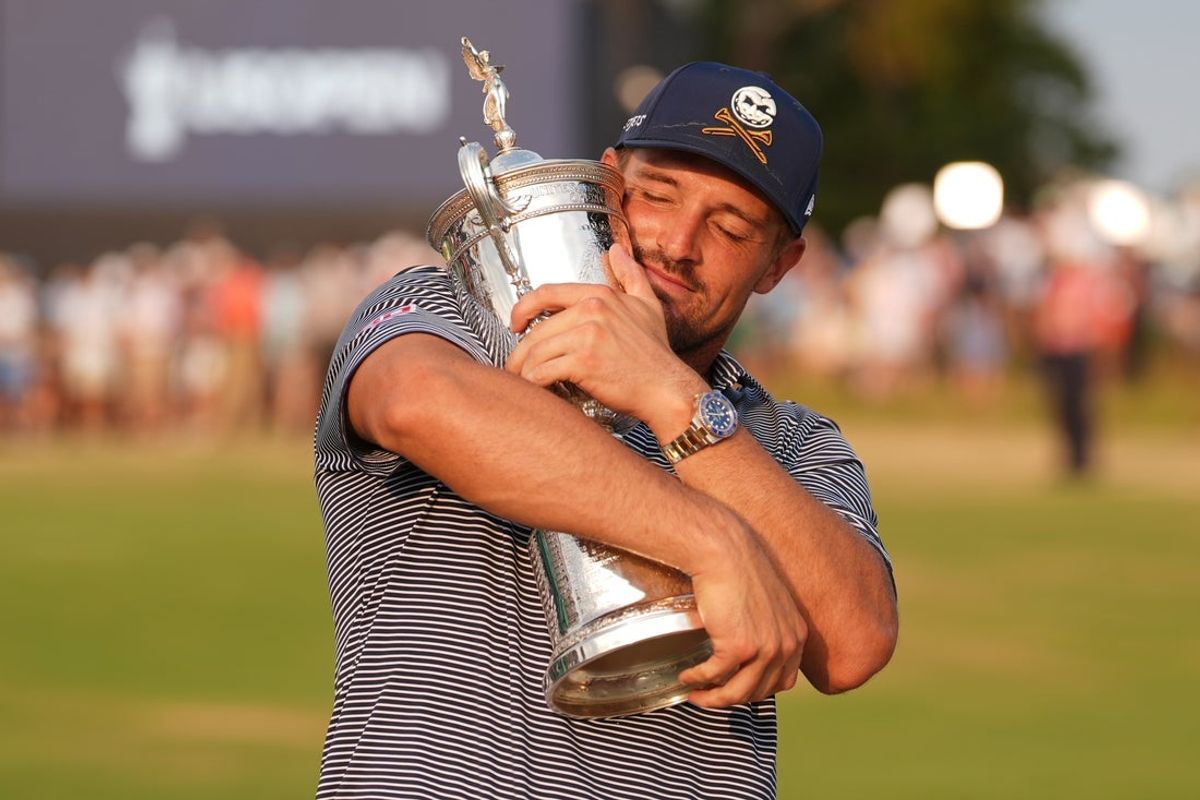 Jun 16, 2024; Pinehurst, North Carolina, USA; Bryson DeChambeau celebrates with the trophy after winning the U.S. Open golf tournament. Mandatory Credit: Jim Dedmon-Imagn Images