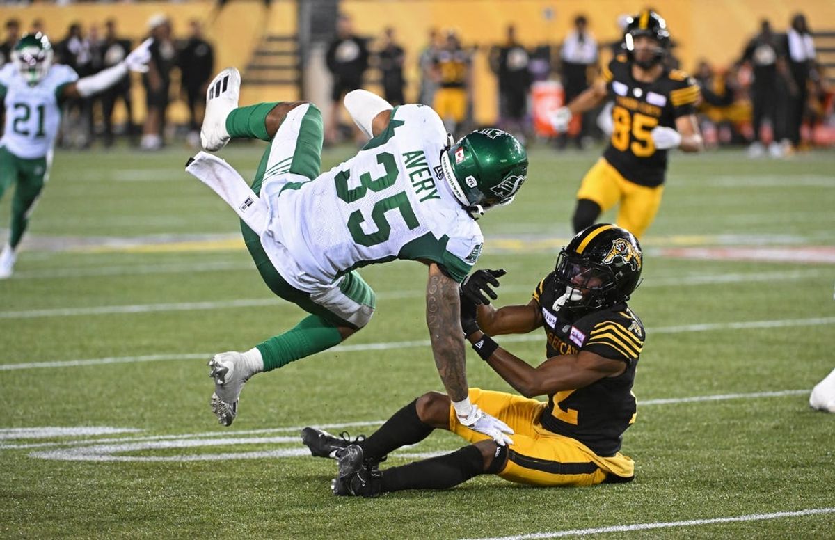 Jun 16, 2024; Hamilton, Ontario, CAN; Saskatchewan Rough Riders linebacker CJ Avery (35) intercepts the ball from Hamilton Tiger Cats wide receiver Tim White (12) in the fourth quarter at Tim Hortons Field. Mandatory Credit: Gerry Angus-USA TODAY Sports