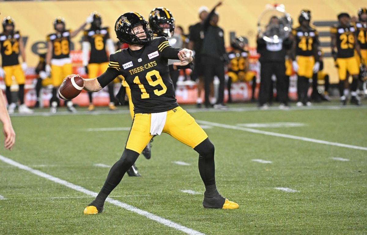 Jun 16, 2024; Hamilton, Ontario, CAN; Hamilton Tiger Cats quarterback Bo Levi Mitchell (19) throws a touchdown pass in the third quarter against the Saskatchewan Rough Riders at Tim Hortons Field. Mandatory Credit: Gerry Angus-USA TODAY Sports