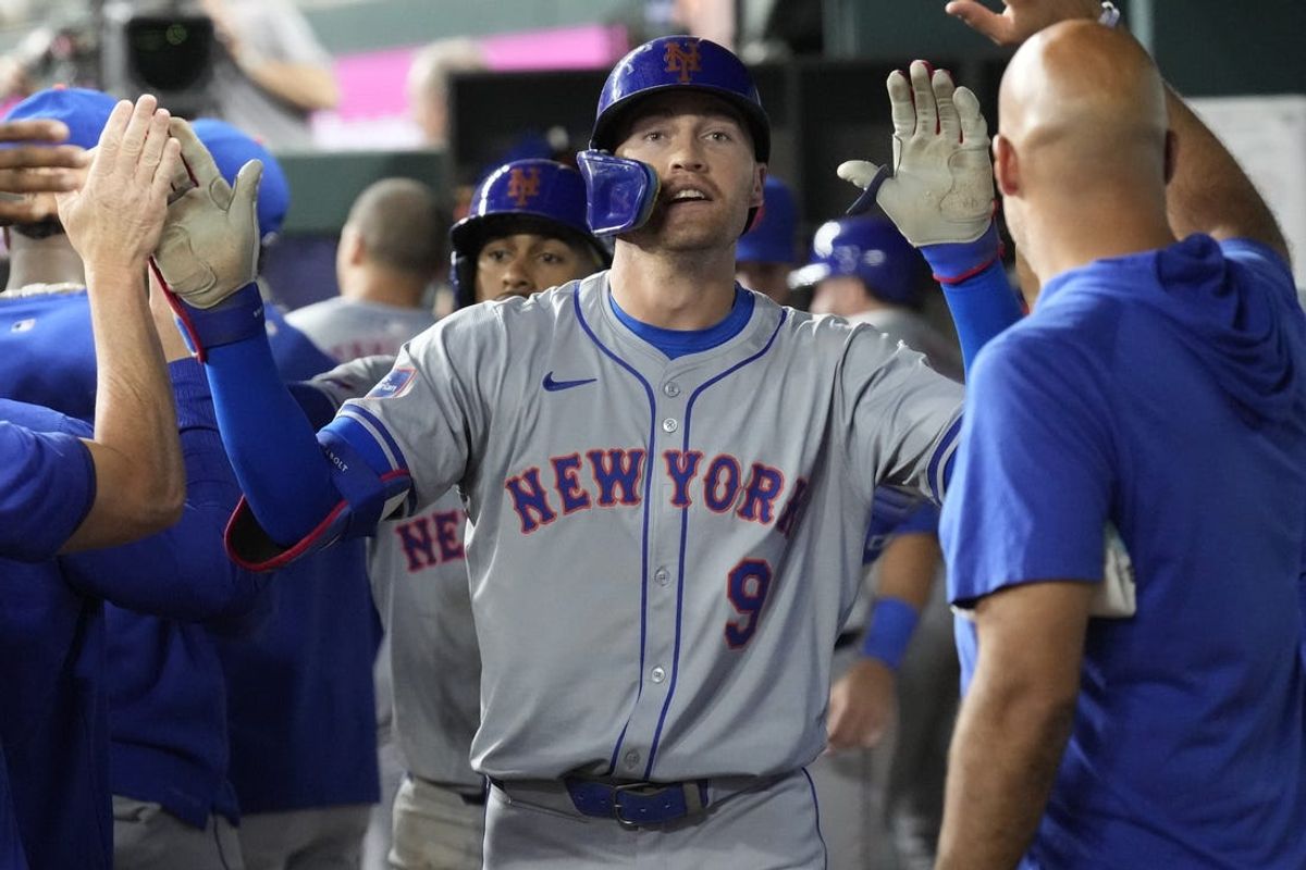 Jun 17, 2024; Arlington, Texas, USA; New York Mets left fielder Brandon Nimmo (9) celebrates his two-run home run with teammates in the dugout against the Texas Rangers during the third inning at Globe Life Field. Mandatory Credit: Jim Cowsert-USA TODAY Sports