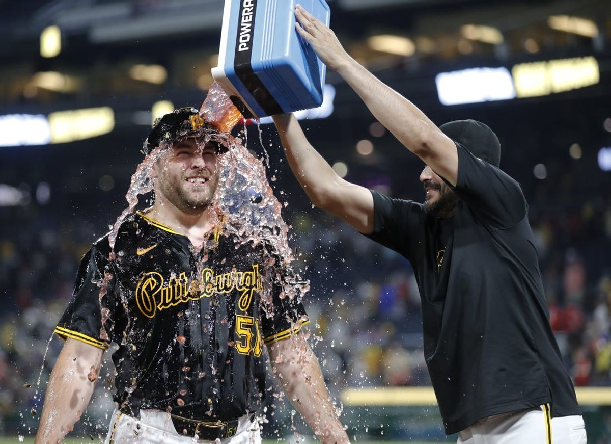 Jun 17, 2024; Pittsburgh, Pennsylvania, USA;  Pittsburgh Pirates pitcher Martin Perez (right) dumps Powerade on relief pitcher David Bednar (51) after the Pirates defeated the Cincinnati Reds at PNC Park. The Pirates won 4-1. Mandatory Credit: Charles LeClaire-USA TODAY Sports