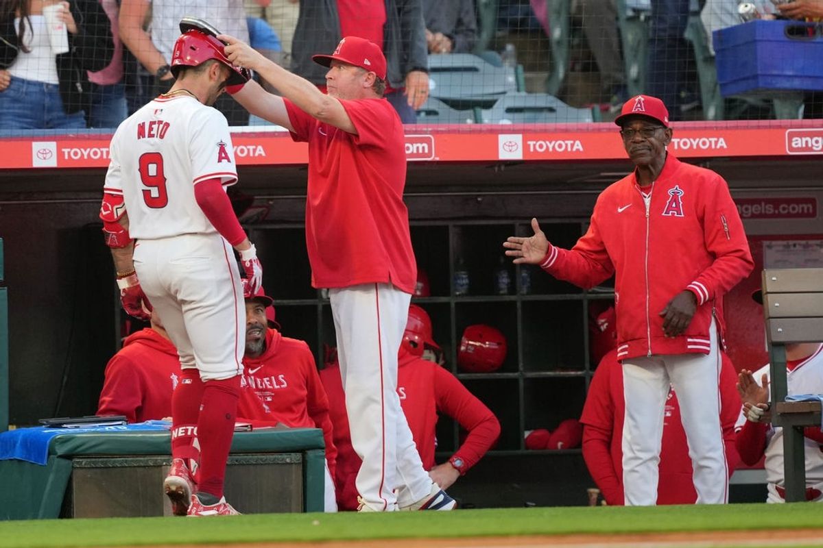 Jun 17, 2024; Anaheim, California, USA; Los Angeles Angels shortstop Zach Neto (9) is congratulated by bench coach Ray Montgomery (81) and manager Ron Washington after hitting a two-run home run in the fourth inning against the Milwaukee Brewers at Angel Stadium. Mandatory Credit: Kirby Lee-USA TODAY Sports