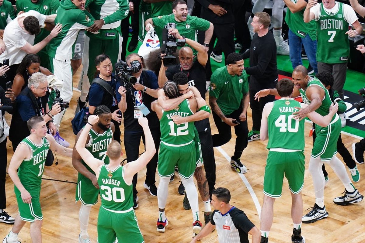 Jun 17, 2024; Boston, Massachusetts, USA; Boston Celtics forward Jayson Tatum (0) celebrates with forward Oshae Brissett (12) after defeating the Dallas Mavericks in game five to win the 2024 NBA Finals at TD Garden. Mandatory Credit: David Butler II-USA TODAY Sports