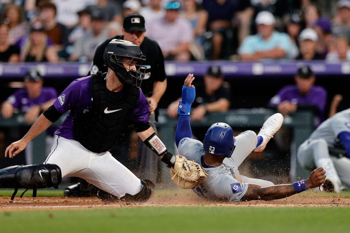Jun 17, 2024; Denver, Colorado, USA; Los Angeles Dodgers right fielder Jason Heyward (23) slides safely past the tag of Colorado Rockies catcher Jacob Stallings (25) on an RBI in the seventh inning at Coors Field. Mandatory Credit: Isaiah J. Downing-USA TODAY Sports