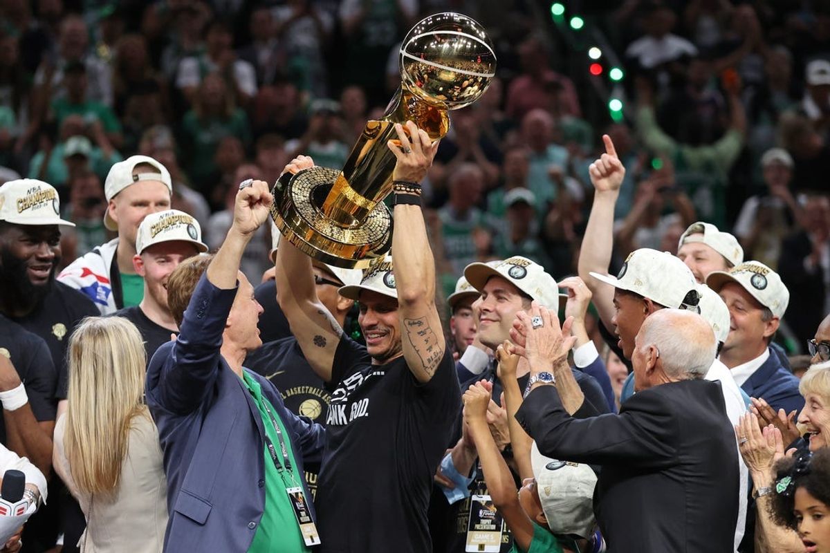 Jun 17, 2024; Boston, Massachusetts, USA; Boston Celtics head coach Joe Mazzulla holds up the trophy as he celebrates after winning the 2024 NBA Finals against the Dallas Mavericks at TD Garden. Mandatory Credit: Peter Casey-USA TODAY Sports