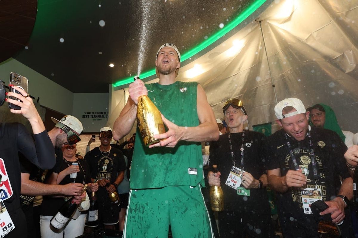 Boston Celtics center Kristaps Porzingis (8) celebrates in the locker room after winning the 2024 NBA Finals against the Dallas Mavericks at TD Garden. Mandatory Credit: Elsa/Pool Photo-USA TODAY Sports