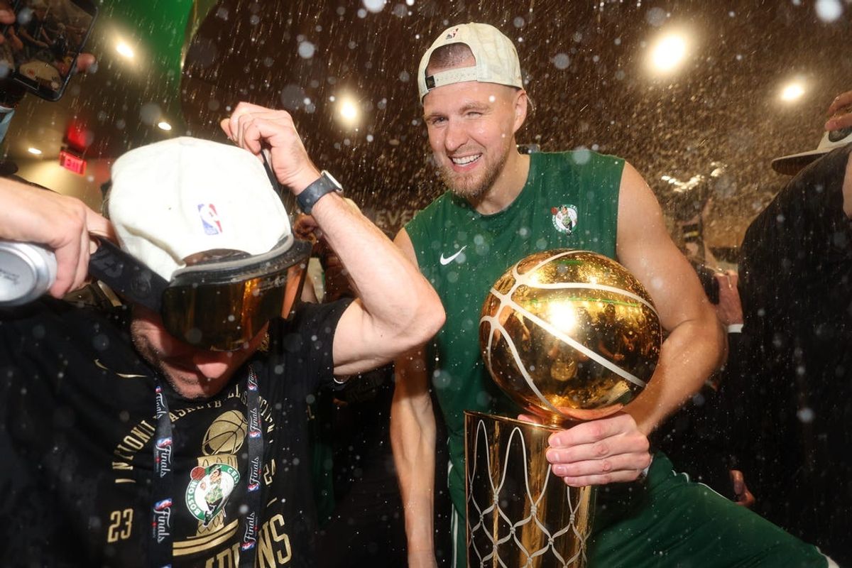 Jun 17, 2024; Boston, Massachusetts, USA; Boston Celtics center Kristaps Porzingis celebrates in the locker room after winning the 2024 NBA Finals against the Dallas Mavericks at TD Garden. Mandatory Credit: Elsa/Pool Photo-USA TODAY Sports