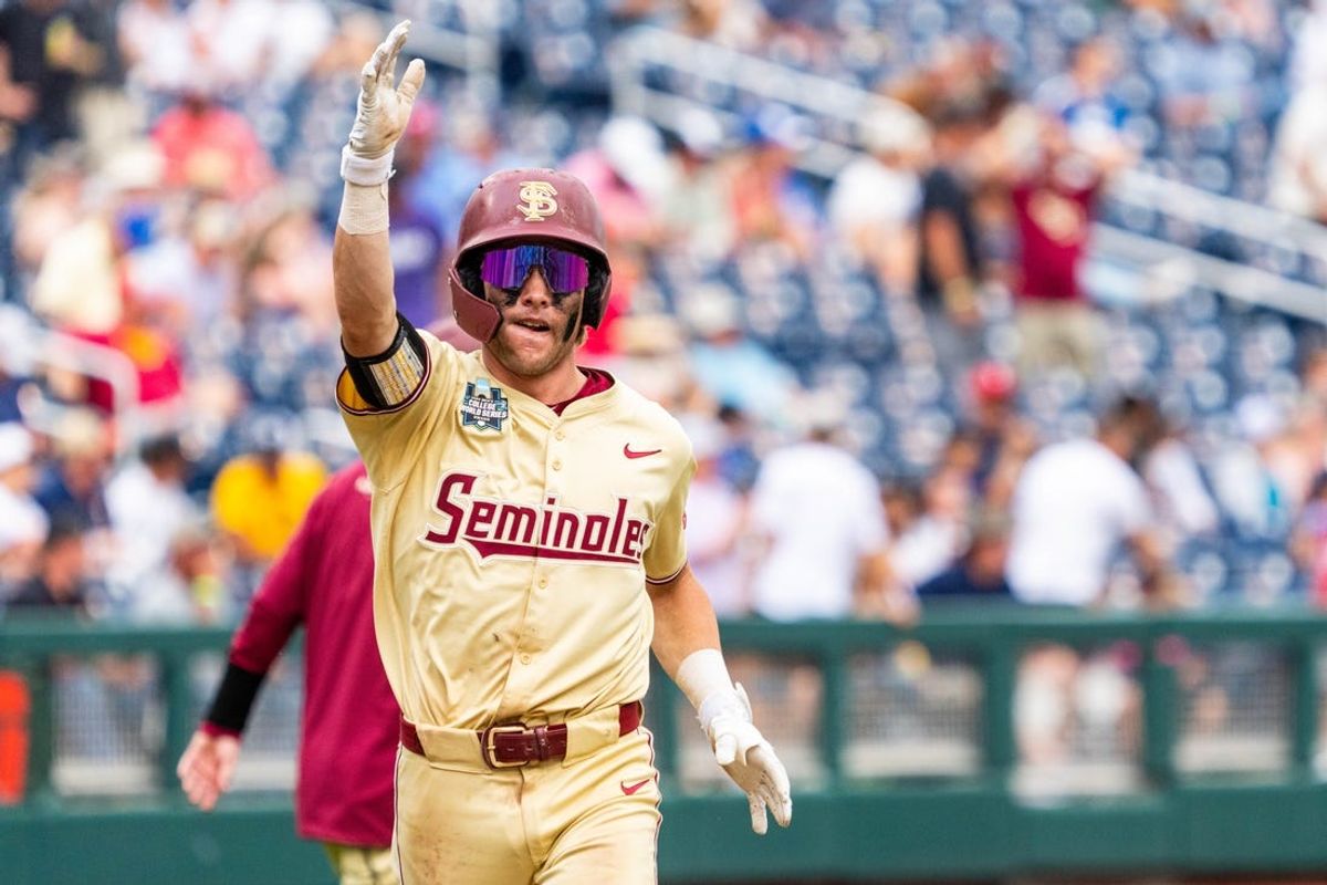 Jun 18, 2024; Omaha, NE, USA; Florida State Seminoles catcher Jaxson West (20) celebrates after hitting a home run against the North Carolina Tar Heels during the ninth inning at Charles Schwab Field Omaha. Mandatory Credit: Dylan Widger-USA TODAY Sports
