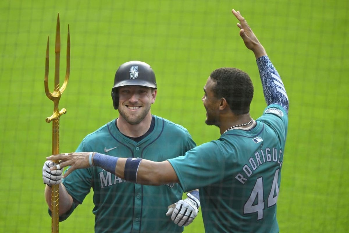 Jun 18, 2024; Cleveland, Ohio, USA; Seattle Mariners left fielder Luke Raley (20) celebrates his solo home run with center fielder Julio Rodriguez (44) in the fifth inning against the Cleveland Guardians at Progressive Field. Mandatory Credit: David Richard-USA TODAY Sports