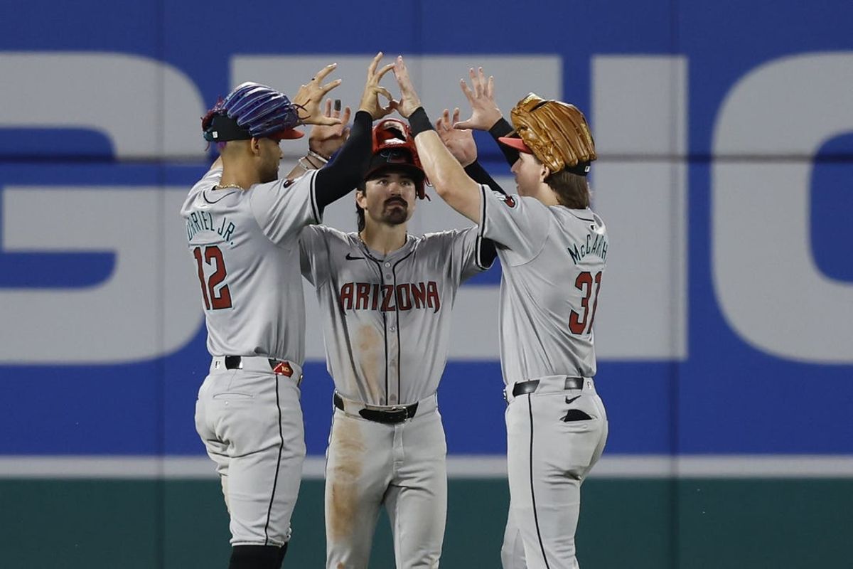 Jun 18, 2024; Washington, District of Columbia, USA; Arizona Diamondbacks outfielder Lourdes Gurriel Jr. (12), Diamondbacks outfielder Corbin Carroll (7), and Diamondbacks outfielder Jake McCarthy (31) celebrate after their game against the Washington Nationals at Nationals Park. Mandatory Credit: Geoff Burke-USA TODAY Sports