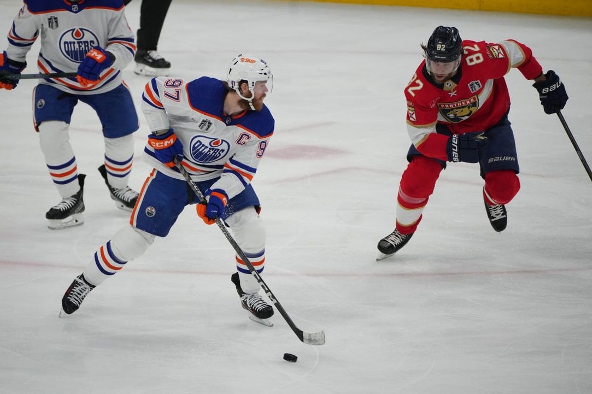 Jun 18, 2024; Sunrise, Florida, USA; Edmonton Oilers forward Connor McDavid (97) controls the puck against Florida Panthers forward Kevin Stenlund (82) during the third period in game five of the 2024 Stanley Cup Final at Amerant Bank Arena. Mandatory Credit: Jim Rassol-USA TODAY Sports