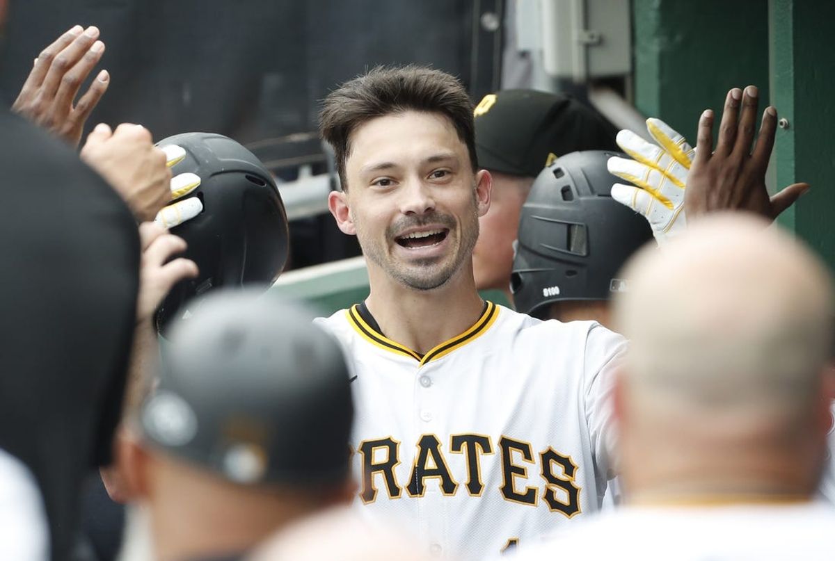 Jun 19, 2024; Pittsburgh, Pennsylvania, USA;  Pittsburgh Pirates left fielder Bryan Reynolds (10) celebrates his solo home run in the dugout against the Cincinnati Reds during the eighth inning at PNC Park. The Pirates shutout the Reds 1-0. Mandatory Credit: Charles LeClaire-USA TODAY Sports